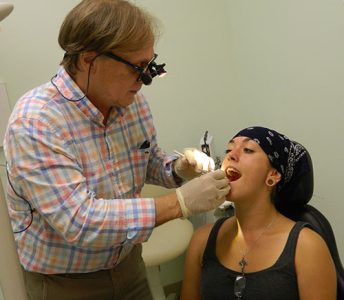 Neighborhood Clinic Impact Gallery: Dentist assisting a patient